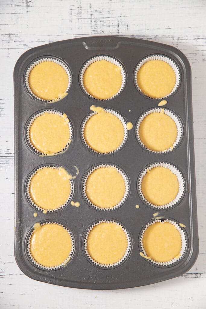 The cornbread muffin batter in a muffin tin