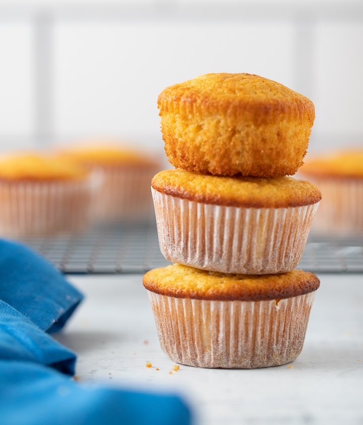 Three cornbread muffins stacked on top of eachother