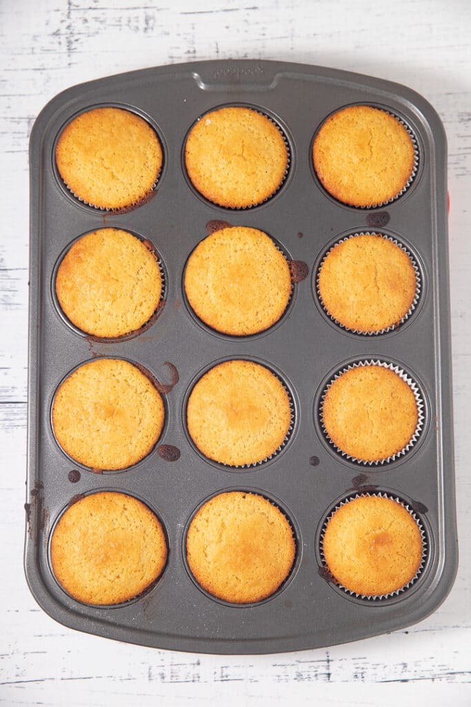 Baked cornbread muffins in a tin