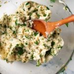 garlic herb butter with wooden spoon in glass bowl