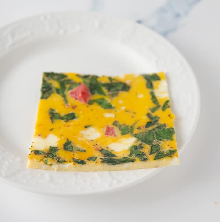 close up of cut egg mixture on white plate