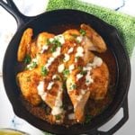 spatchcocked chicken in cast iron skillet