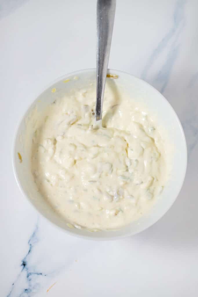 Tartar sauce in a white bowl with a spoon