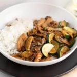 zucchini mushroom chicken on a white plate