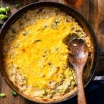 broccoli rice casserole in dish with spoon in it