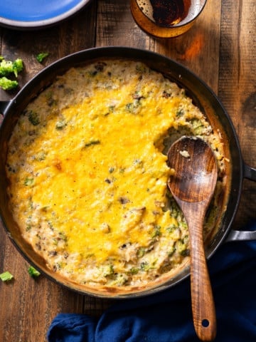 broccoli rice casserole in dish with spoon in it