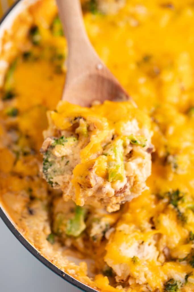 Broccoli rice casserole on a wooden spoon