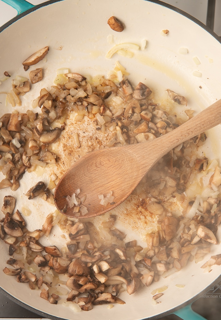 Mushrooms and onions cooking in a pan