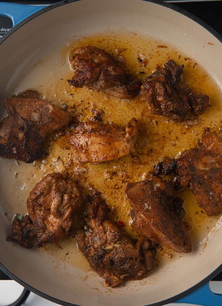 chicken being browned in pan