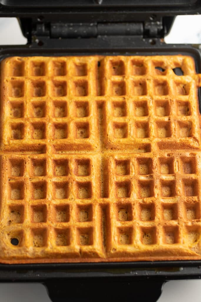 The cooked waffles in the waffle iron