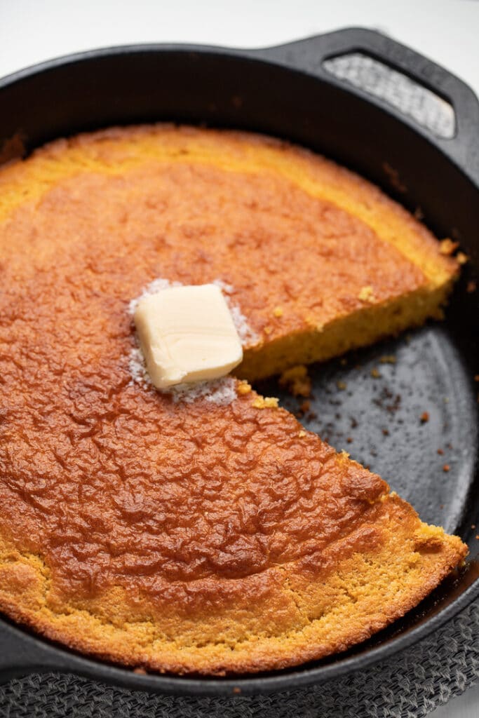 cornbread in skillet with butter on top