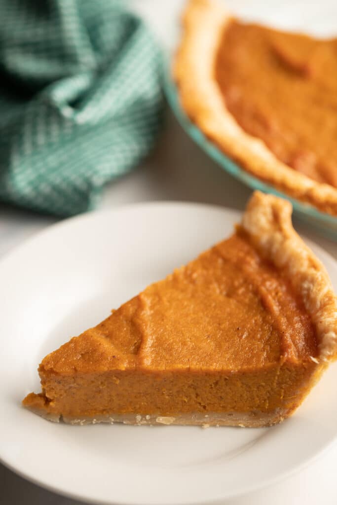 A slice of southern sweet potato pie served on a white plate