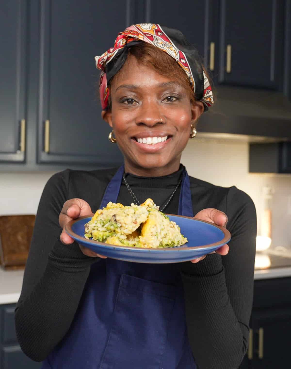 tanya holding a plate of broccoli rice casserole