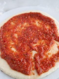 The sauce spread on pizza dough.