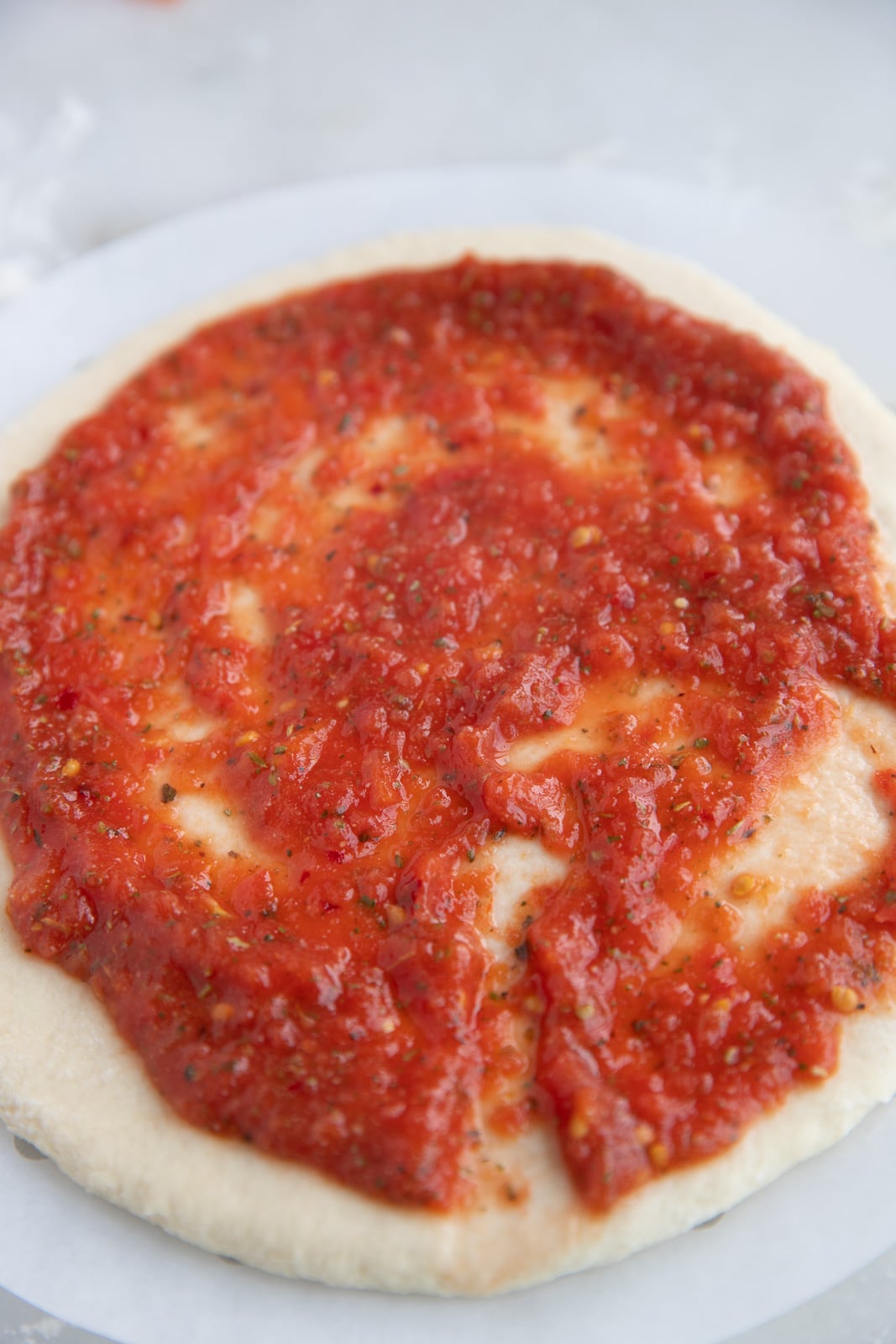 The sauce spread on pizza dough.