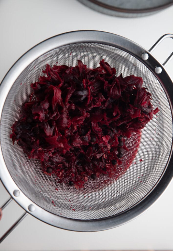 Straining the mixture through a fine mesh sieve