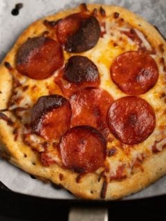 cooked pizza in air fryer basket