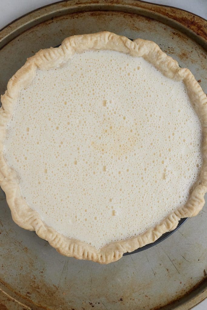 The filling poured into the part baked pie crust.