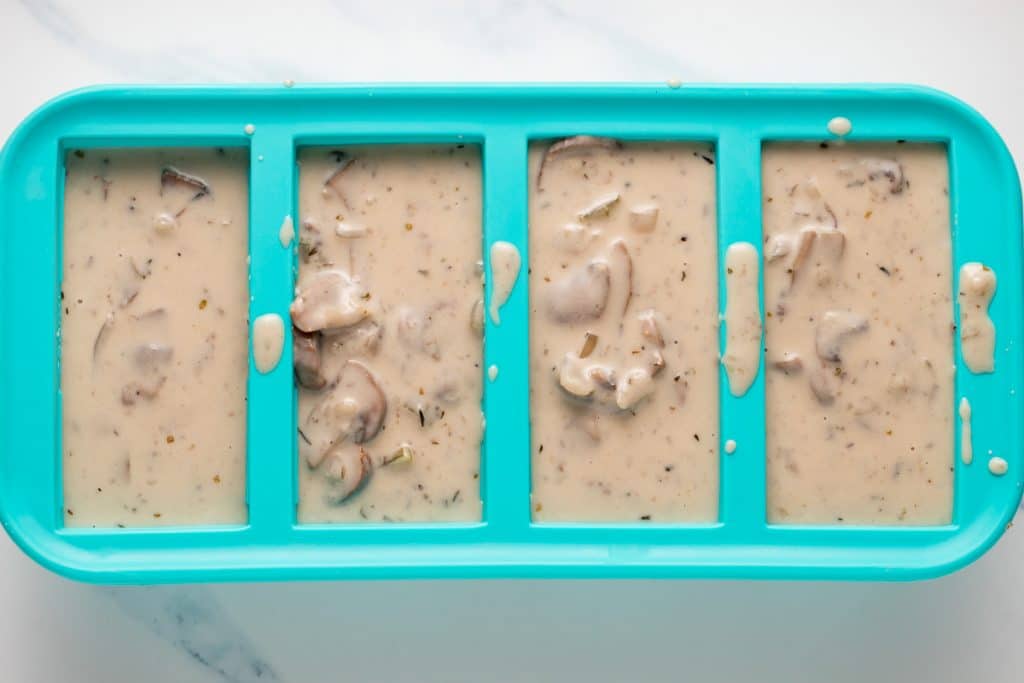 The mushroom soup in a large ice cube tray.