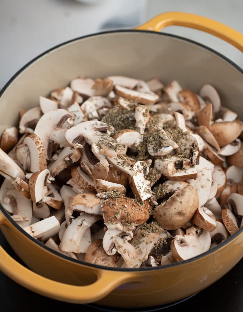 Mushrooms and herbs added to the pot.