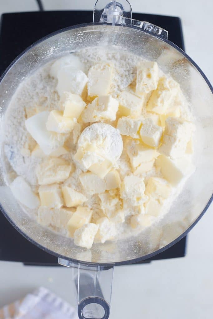 Butter squares added to the flour.