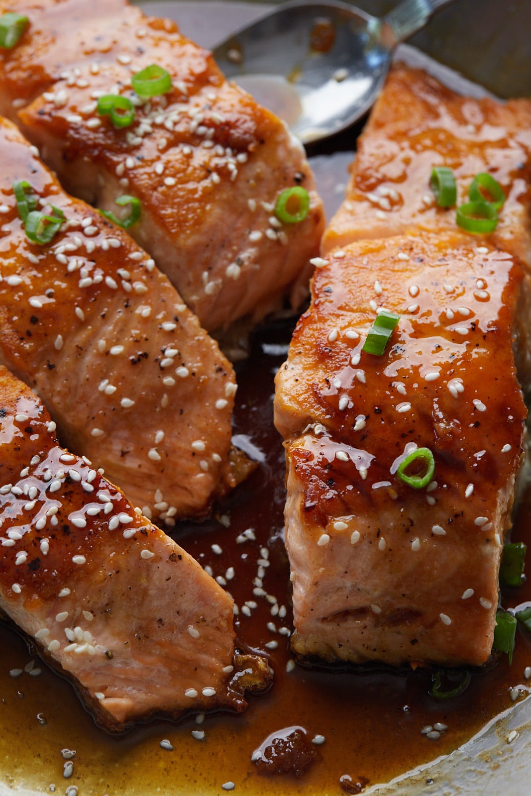 Close up of four pieces of teriyaki salmon.