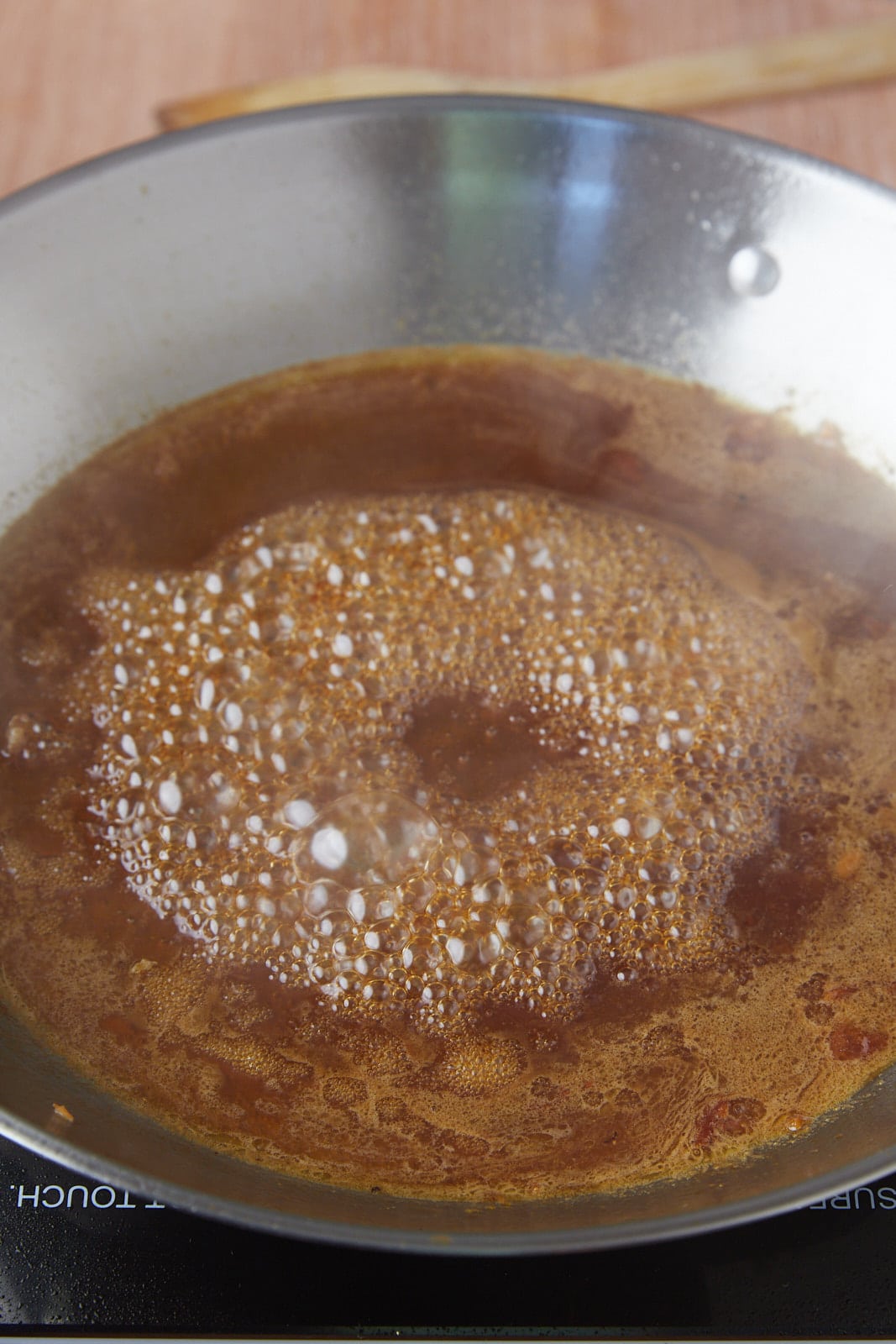 The sauce simmering in the pan.