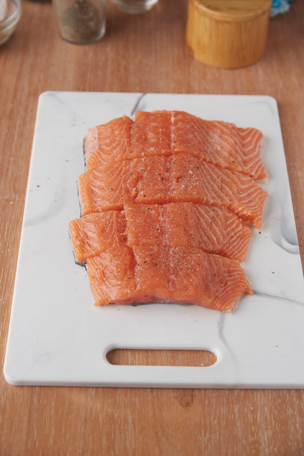 A fillet of salmon cut into 4 pieces.