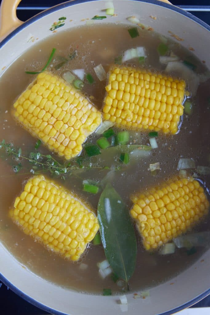 Four pieces of corn in the broth.