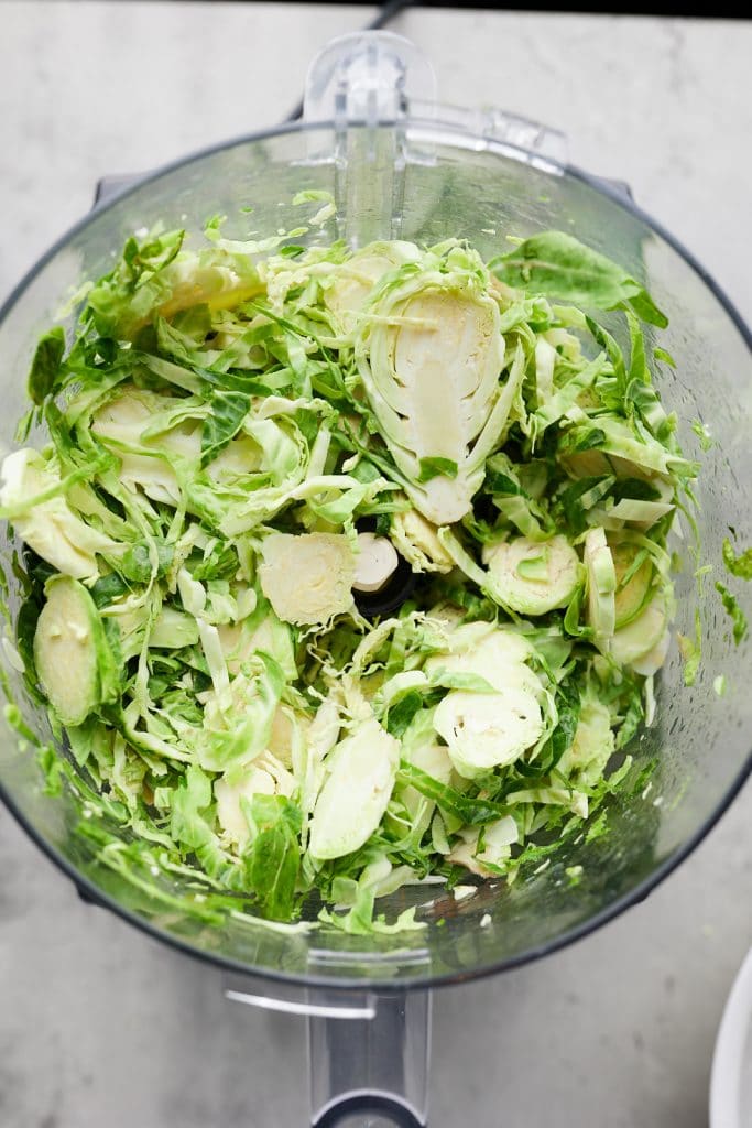 The shaved Brussels sprouts in a food processor.