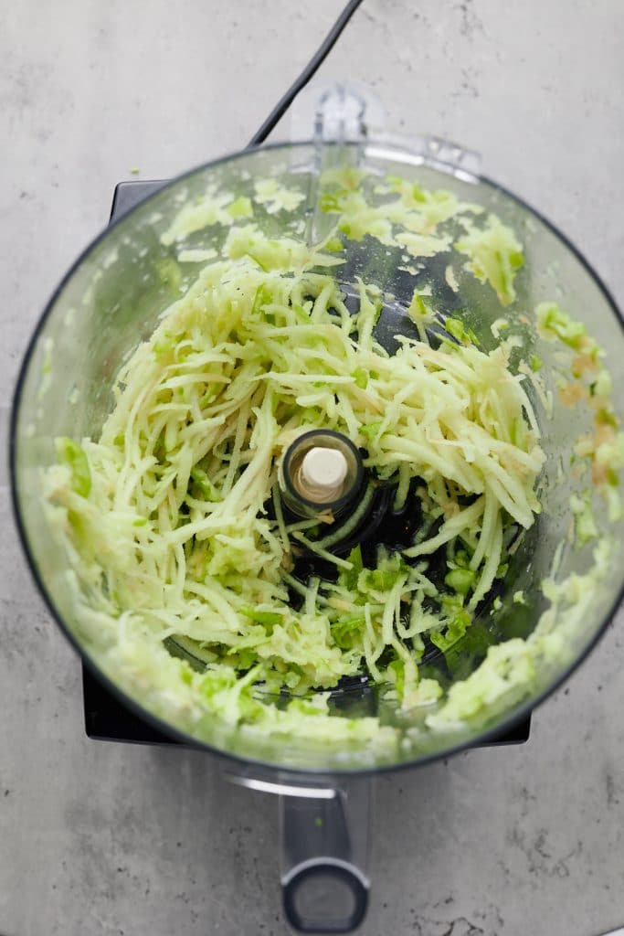 Shredded apples in a food processor.