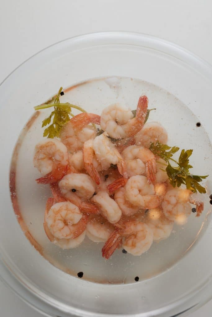 Cooked shrimp in a glass bowl.