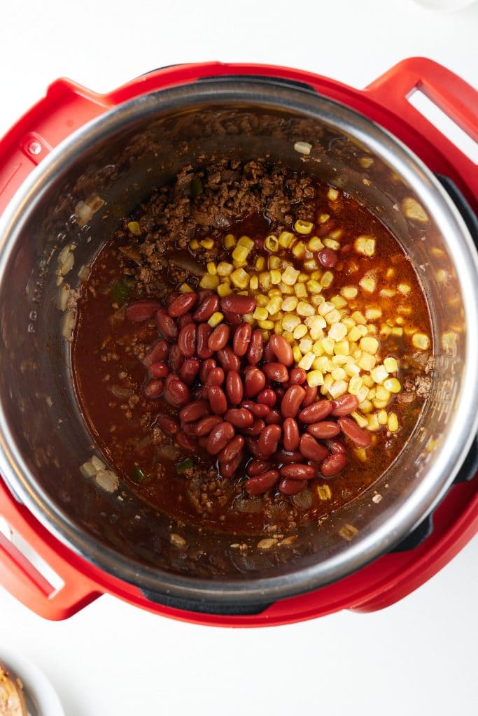 Beans and corn added to the pressure cooker.