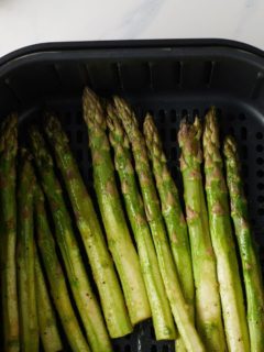 asparagus in an air fryer basket