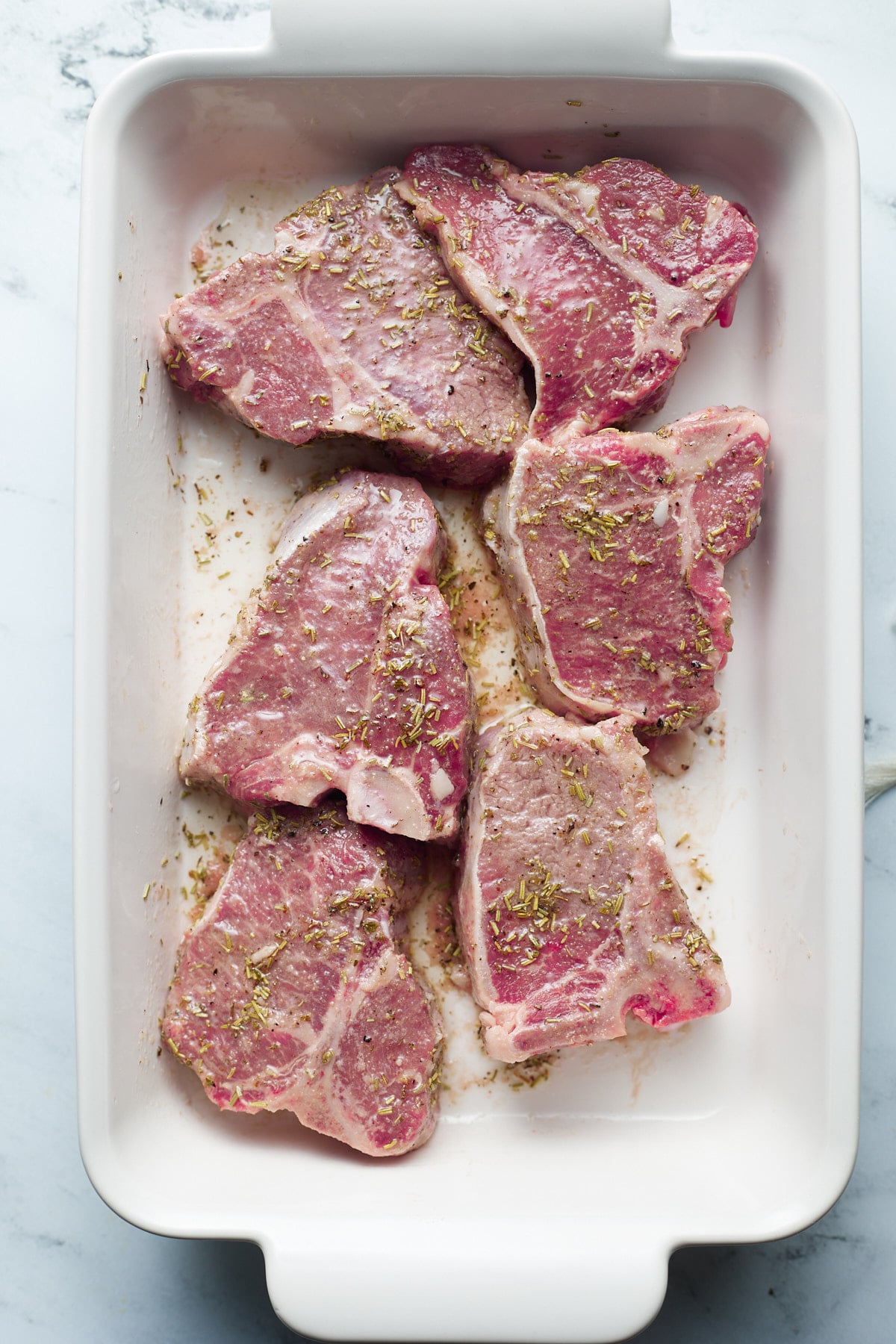 Raw lamb chops in the marinade.