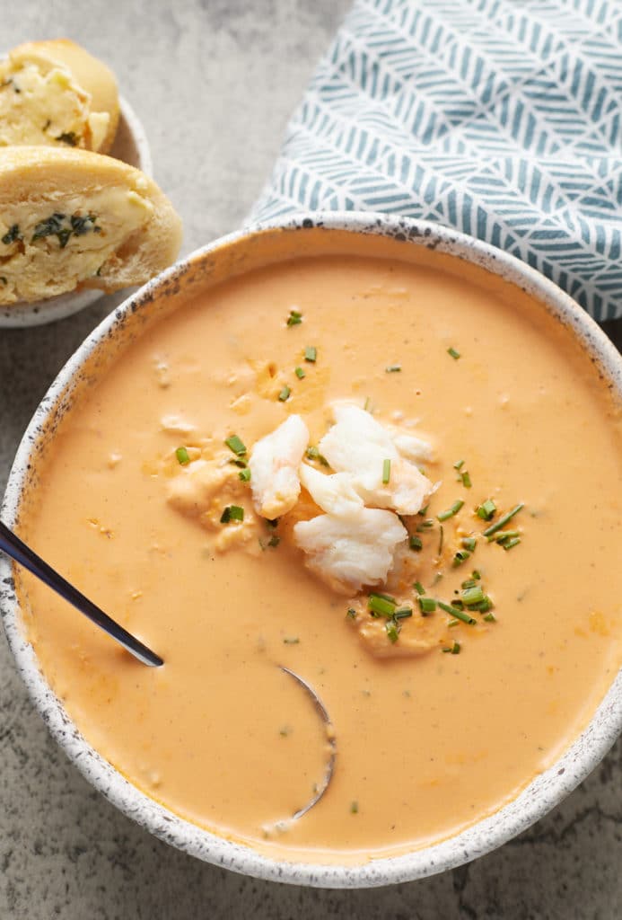 crab bisque in a bowl with spoon in it