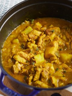 The finished chicken curry in a blue dutch oven.