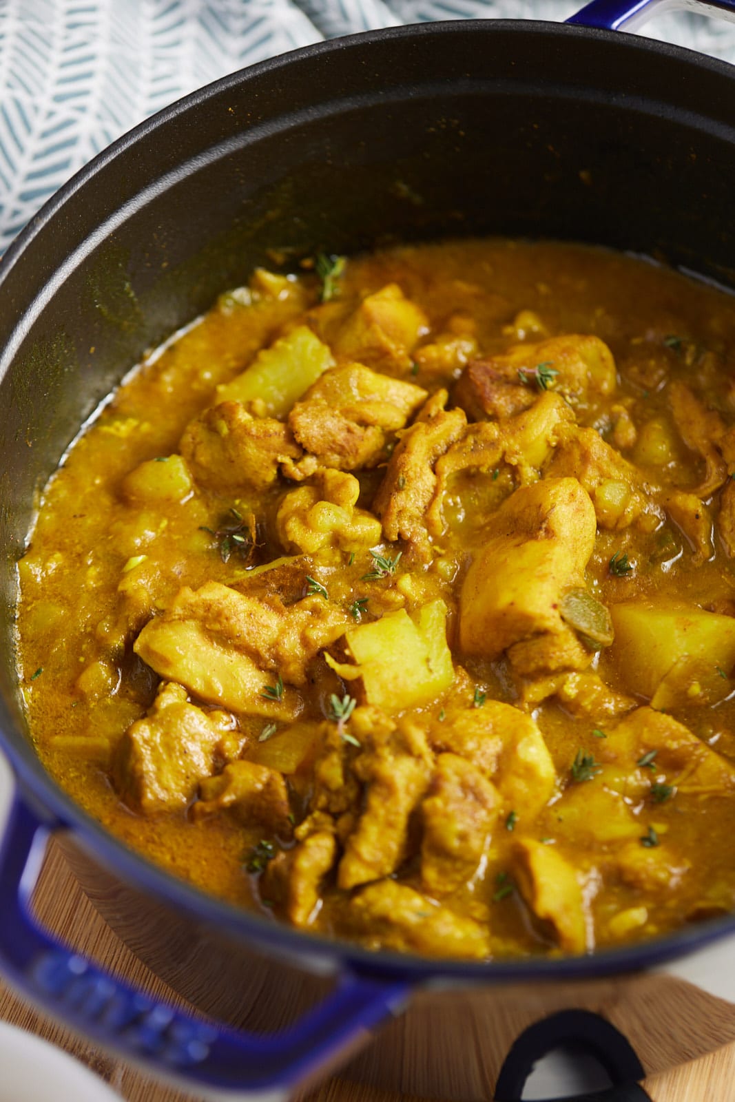 The finished chicken curry in a blue dutch oven.