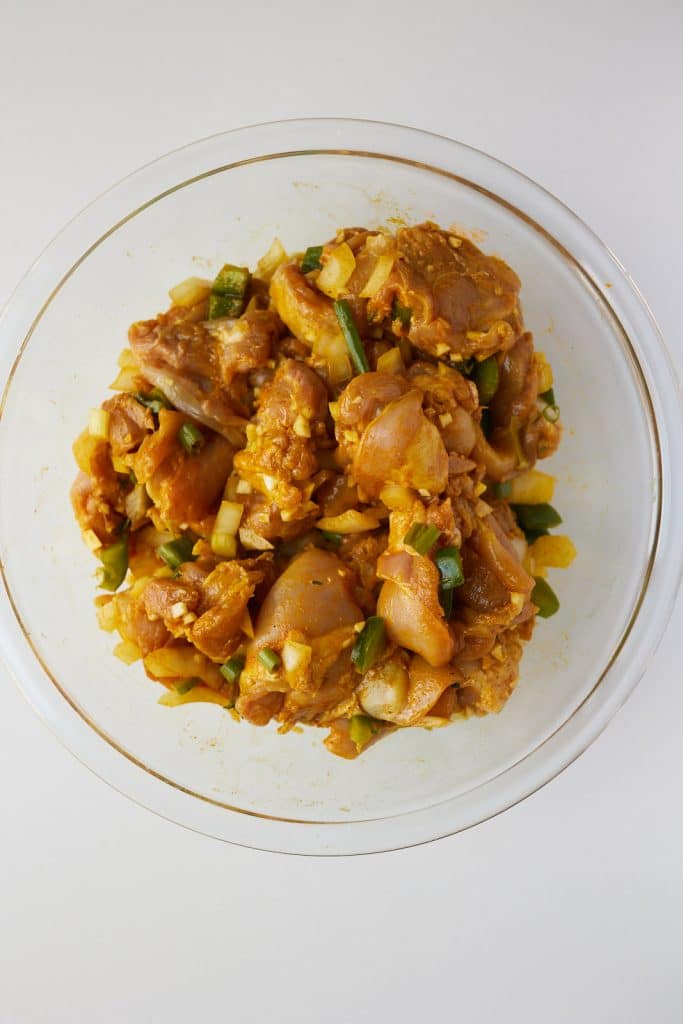 raw chicken seasoned with curry powder and spices