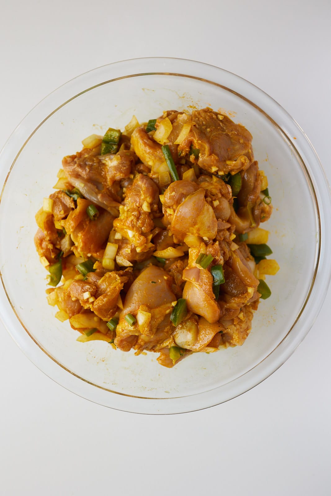 raw chicken seasoned with curry powder and spices