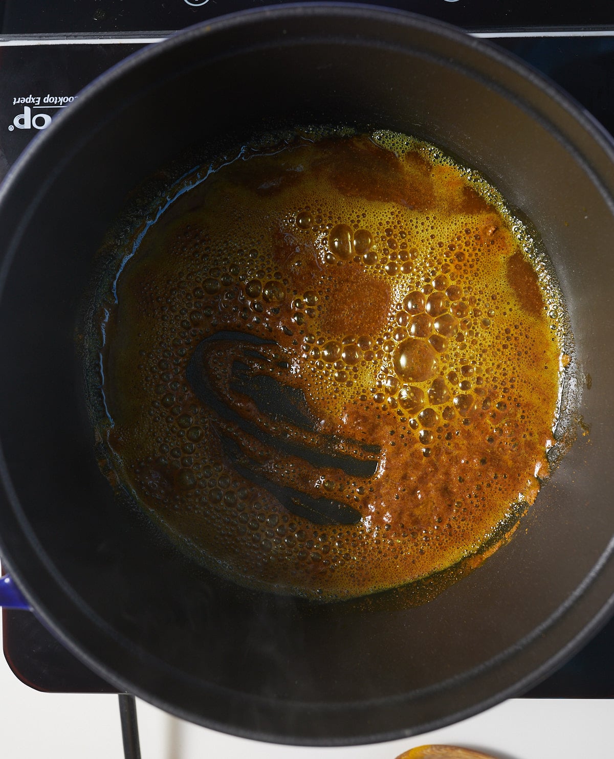 Curry powder and oil in a pot.