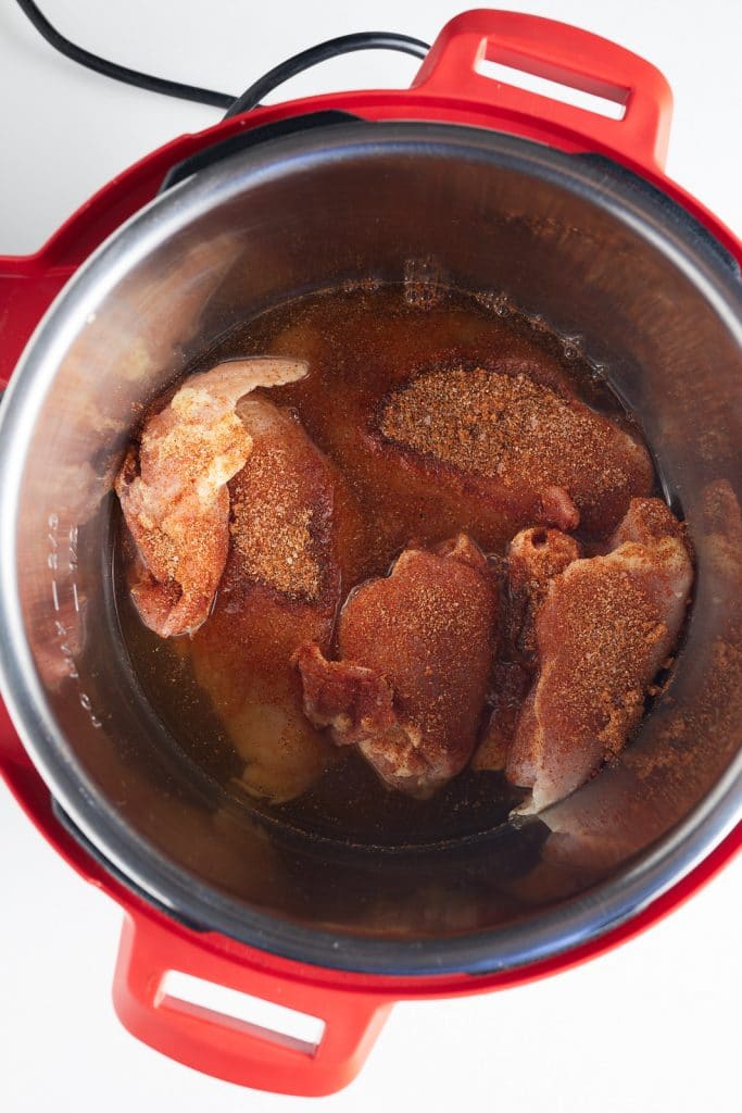 The chicken and other ingredients in the Instant Pot ready to cook.