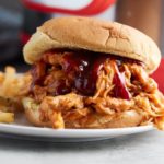 Close up of pressure cooker BBQ chicken served in a burger bun.