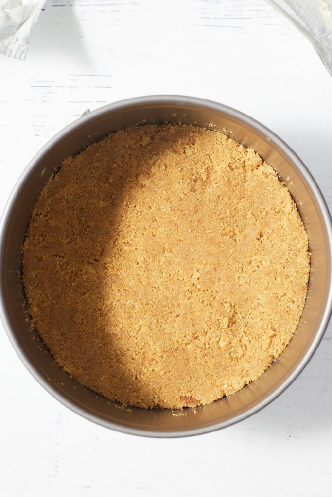 The cheesecake crust in a springform pan.