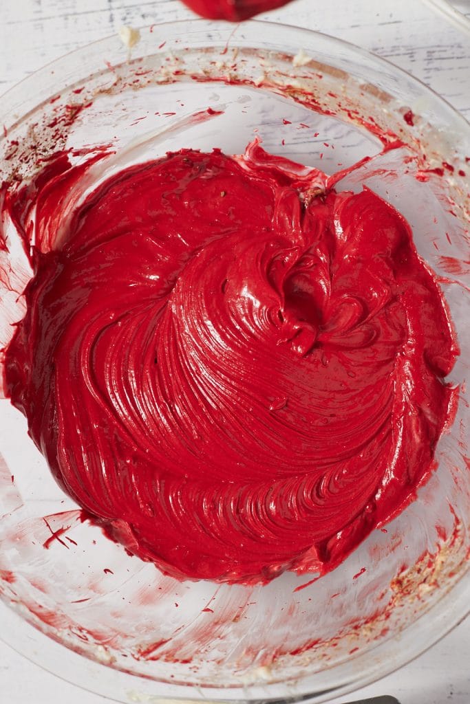 The red cake batter in a glass bowl.