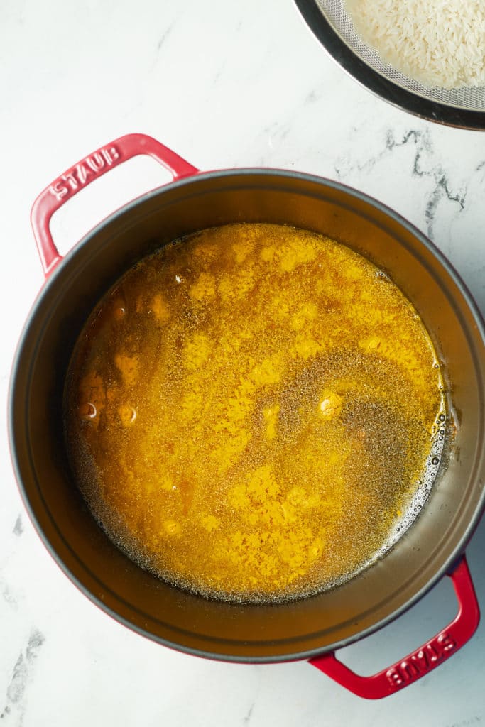 Seasonings and water added to a large pot.