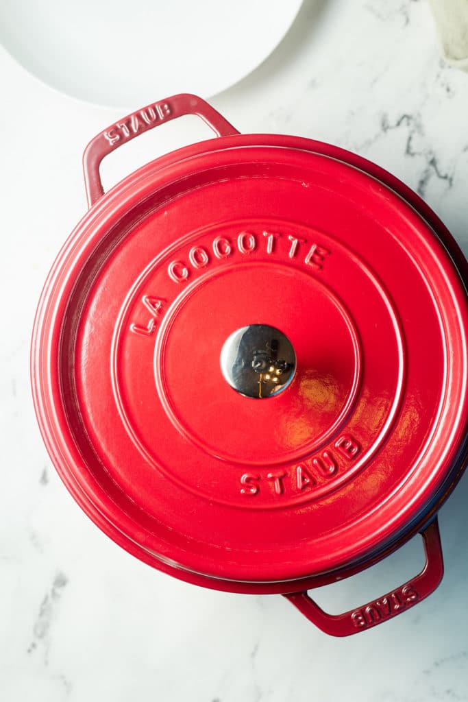 A red pot with a lid on it.