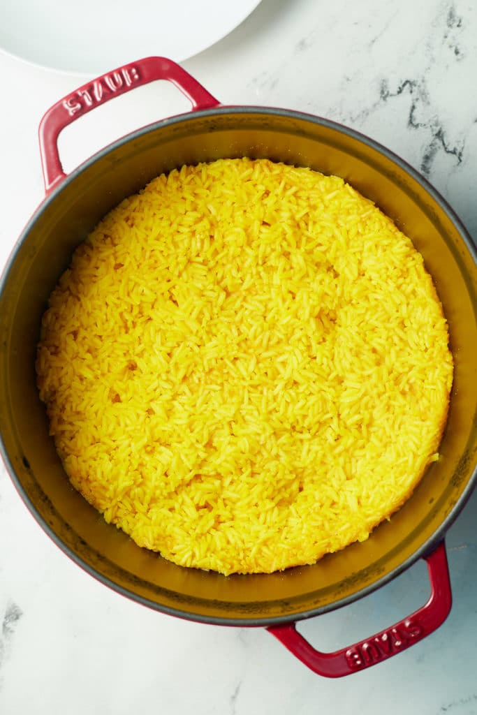The yellow rice in the pot after cooking.