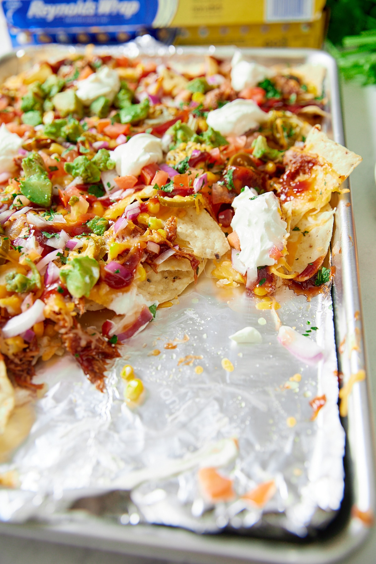 finished bbq nachos with some removed and foil showing