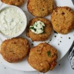 air fryer salmon patties on white plate with tartar sauce on one